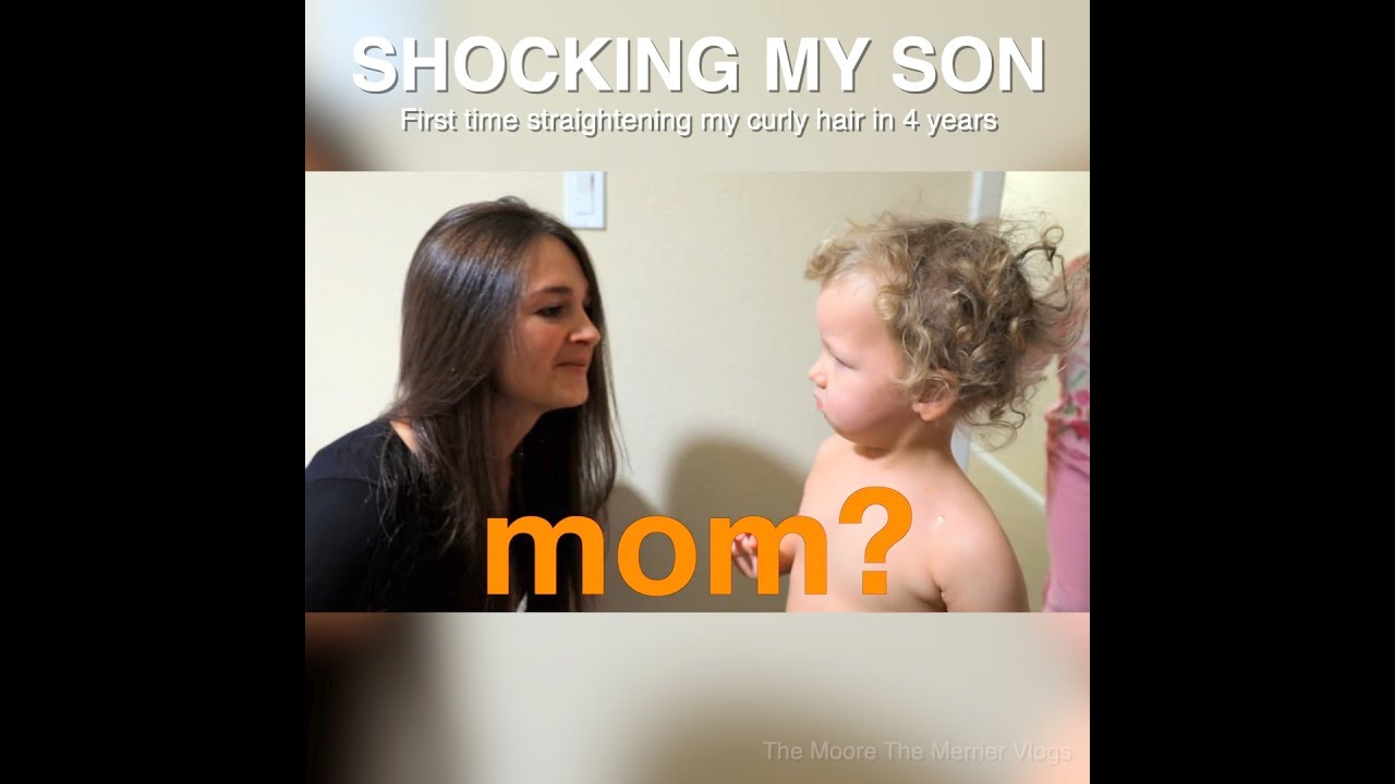 Mother and curly-haired toddler face each other; bold orange 'mom?' overlay and 'SHOCKING MY SON' title at top.
