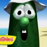 Animated green bean character with a big nose and hat on a sunny beach, VeggieTales logo in the bottom-left.