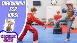 Thumbnail for Taekwondo for Kids: cartoon cowboy on the left; on the right, a red‑uniform instructor holds a kicking pad while a cowboy‑hatted man performs a kick in a dojo setting.
