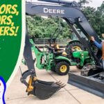 Cowboy-presenter in a hat beside a John Deere excavator, with a green banner that says 'EXCAVATORS, TRACTORS, SKID STEERS!' and a 'COWBOY JACK' logo on the left.