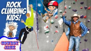 Banner promoting kids rock climbing with cartoon cowboys, a real instructor in a cowboy hat, and a climbing wall.