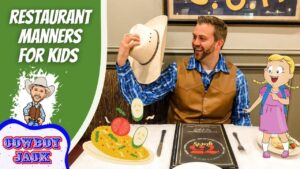 Man in a brown vest and blue plaid shirt lifts his hat and smiles at a cartoon girl with a backpack at a restaurant table; left side shows a green banner reading 'Restaurant Manners for Kids' with 'Cowboy Jack' logo; plate of food and a menu are on the table.