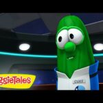 Green cucumber VeggieTales character in a blue-and-white uniform with a 'Cuke' name tag, inside a futuristic control room.