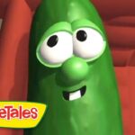 Green VeggieTales character with big googly eyes and a smile, logo visible in bottom-left corner.