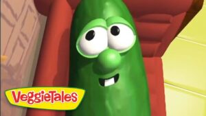 Green VeggieTales character with big googly eyes and a smile, logo visible in bottom-left corner.