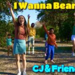 Group of diverse kids in an orange orchard, waving happily; title reads 'I Wanna Bear Fruit' and 'CJ & Friends' with a cartoon monkey.