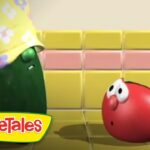 Green pepper character wearing a floral yellow hat leans toward a surprised red tomato in a yellow-tiled kitchen; VeggieTales logo bottom left.