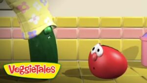 Green pepper character wearing a floral yellow hat leans toward a surprised red tomato in a yellow-tiled kitchen; VeggieTales logo bottom left.