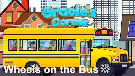 Illustrated yellow school bus with children looking out the windows in a city setting; 'Gracie's Corner' title above and 'Wheels on the Bus' caption.