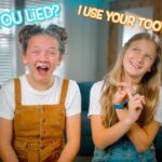 Two smiling girls sitting on a couch, one in tan overalls and the other in denim, with bold captions: 'Have you lied?' and 'I use your toothbrush'.
