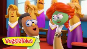 Two VeggieTales characters sing on a stage with a banana-chorus behind them; VeggieTales logo in the corner.