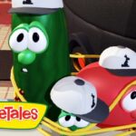 VeggieTales logo with cucumber and tomato characters wearing caps riding in a yellow wagon.