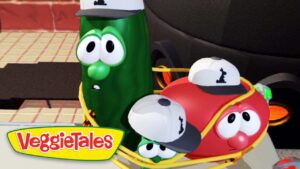 VeggieTales logo with cucumber and tomato characters wearing caps riding in a yellow wagon.