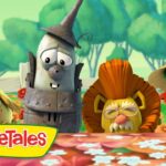Three VeggieTales characters lean over a flowered table with the VeggieTales logo in the foreground.