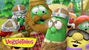 Group of VeggieTales characters in medieval armor pose together with the VeggieTales logo in the lower-left corner, outdoors in a green, forested setting.