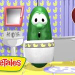 Green veggie character in a bathroom with yellow duck wallpaper and a toilet, from VeggieTales (video thumbnail).