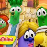 Group of colorful VeggieTales characters posing together with the VeggieTales logo in the foreground, orange desert-like background.