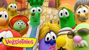 Group of colorful VeggieTales characters posing together with the VeggieTales logo in the foreground, orange desert-like background.