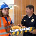 Construction worker in an orange safety vest and blue helmet talks with a police officer in a courthouse lobby; a 'CRIME SCENE' overlay is across the image.