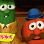 Green cucumber character in a tan plaid suit stands next to a red tomato character with a blue hat and big mustache; VeggieTales logo in the corner.