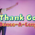 Two girls dancing against a pink backdrop with a bright, colorful title reading 'I Thank God Dance-A-Long' overlaid in the center text.
