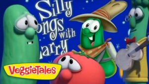 VeggieTales scene with green cucumber characters; one wears a hat and plays a banjo, others look on; text reads Silly Songs with Larry on a blue background with VeggieTales logo.