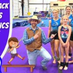 Thumbnail of a cowboy in a hat posing with five young gymnasts on a purple gym floor, with the title 'Cowboy Jack Learns Gymnastics' text on the left panel