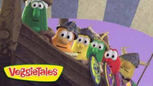VeggieTales characters lean over the wooden ship railing, ready for adventure.