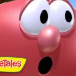 Close-up of a red VeggieTales character with wide eyes and open mouth, desert background, VeggieTales logo in the corner.