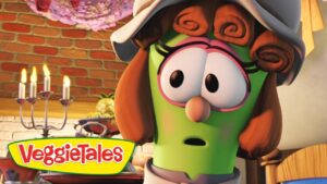 Animated green vegetable character with a hat and large eyes, looking surprised in a kitchen; VeggieTales logo in the lower-left corner.