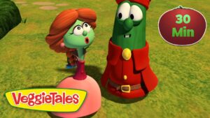 Two VeggieTales characters stand on a grassy field, one with orange hair and a pink dress and the other in a red outfit, both looking surprised. VeggieTales logo appears bottom left and a 30 Min badge is on the top right.