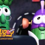 Two animated insects in a car, one green with glasses and the other purple, looking surprised; Larva cartoon logo in the corner.