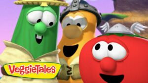 Three VeggieTales characters smiling together with the VeggieTales logo in the foreground, colorful cartoon vegetables wearing hats in a bright scene.
