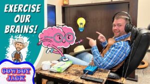 Video thumbnail: a smiling man in a headset sitting in a recliner, pointing at a large cartoon pink brain with glasses and a glowing lightbulb, beside bold ‘EXERCISE OUR BRAINS!’ text and a ‘COWBOY JACK’ logo.