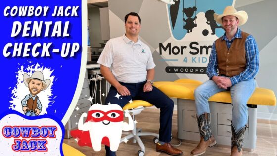 Two men sit on a yellow dental chair in a bright clinic, with a cowboy-themed banner reading 'Cowboy Jack Dental Check-Up' and a cartoon tooth character in front.