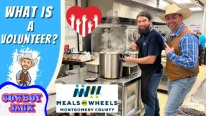 Two volunteers in a kitchen stand by a steaming large pot, promoting volunteers for Meals on Wheels Montgomery County (thumbnail text: 'What is a Volunteer?').**Letβs adjust to ensure clarity**