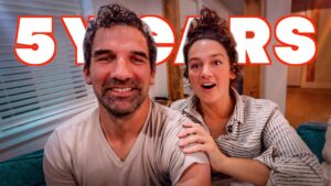 Smiling couple on a couch with bold red '5 YEARS' text overlay, suggesting an anniversary video.