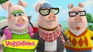 Three anthropomorphic pigs in colorful outfits pose together outdoors, VeggieTales logo at the bottom-left.