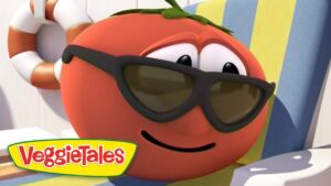 Smiling red tomato from VeggieTales wearing sunglasses and relaxing on a striped pool chair, with a life preserver in the background and VeggieTales logo nearby.