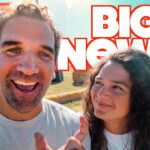 Two friends take a cheerful selfie outdoors with a bold 'BIG NEWS!' headline overlay in white and red letters.