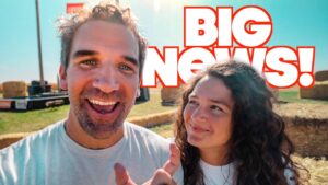 Two friends take a cheerful selfie outdoors with a bold 'BIG NEWS!' headline overlay in white and red letters.