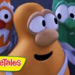 Three animated vegetables in tuxedos posing together, VeggieTales logo in the bottom-left corner.