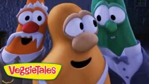 Three animated vegetables in tuxedos posing together, VeggieTales logo in the bottom-left corner.