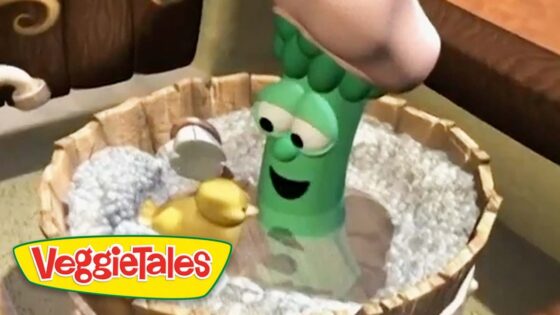 Green VeggieTales character with a smiling face in a wooden tub with white pebbles and a yellow duck nearby, VeggieTales logo bottom left.