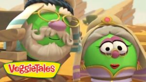 Two green VeggieTales characters in a desert setting, one with glasses and a beard and the other princess-like, with VeggieTales logo in view.