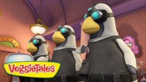 Three penguin-like characters wearing goggles stand in a colorful room, VeggieTales logo in the foreground, likely a scene from an episode.