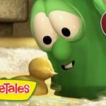 Green VeggieTales character leaning toward a small yellow duckling in a watery scene, logo visible on the bottom left.