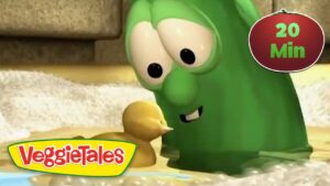 Green VeggieTales character leaning toward a small yellow duckling in a watery scene, logo visible on the bottom left.