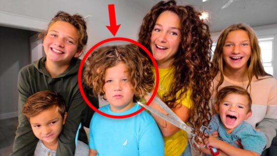 Group of smiling siblings posing together; a red circle marks a boy with curly hair as a pair of scissors hovers nearby, suggesting a haircut moment in progress.