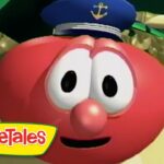 Close-up of a red round VeggieTales character with large eyes, a blue captain's hat with an anchor, and a smile.